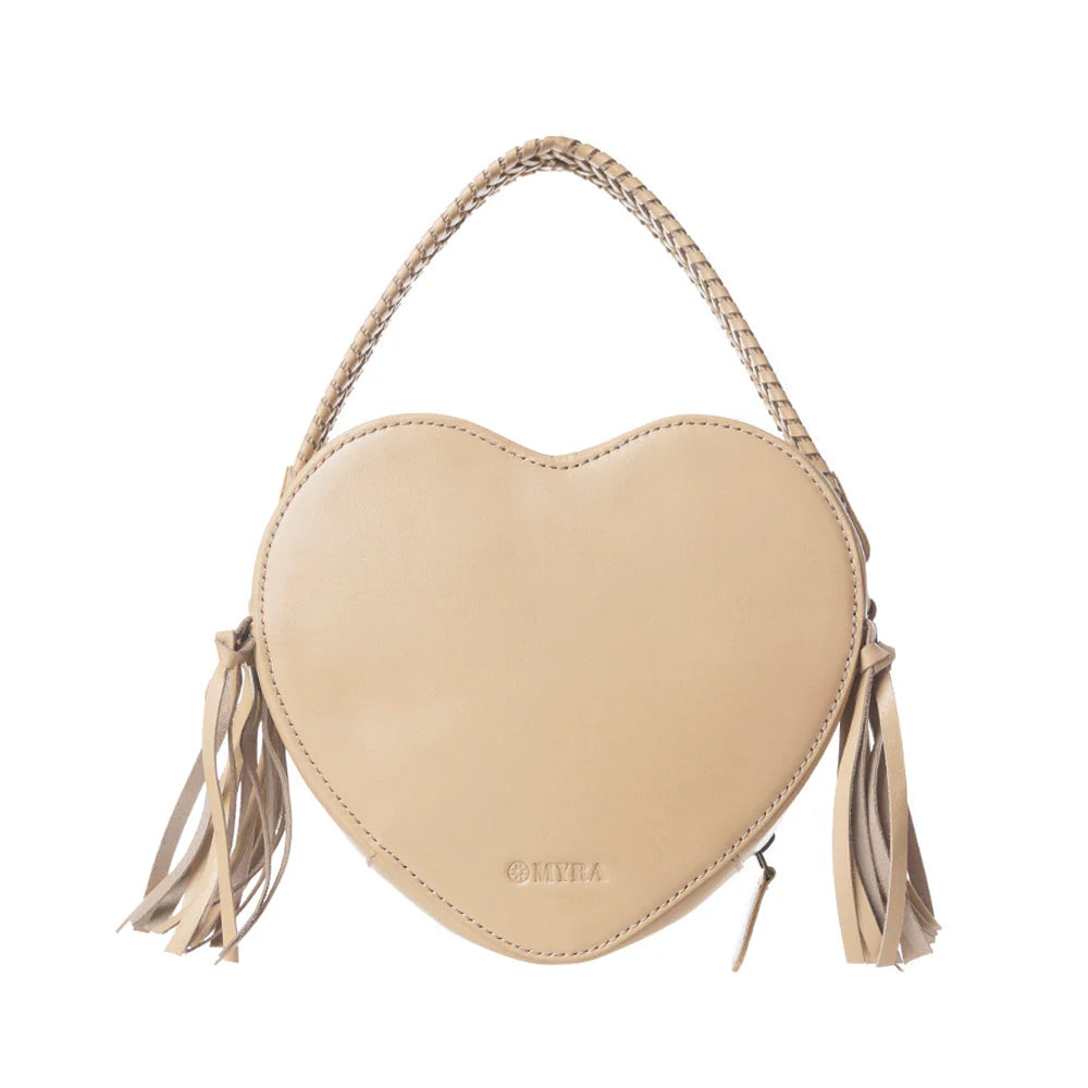 Heart-shaped handbag with intricate designs and tassels on a white background