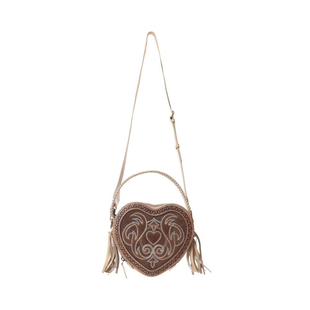 Heart-shaped bag with intricate designs and tassels on a white background