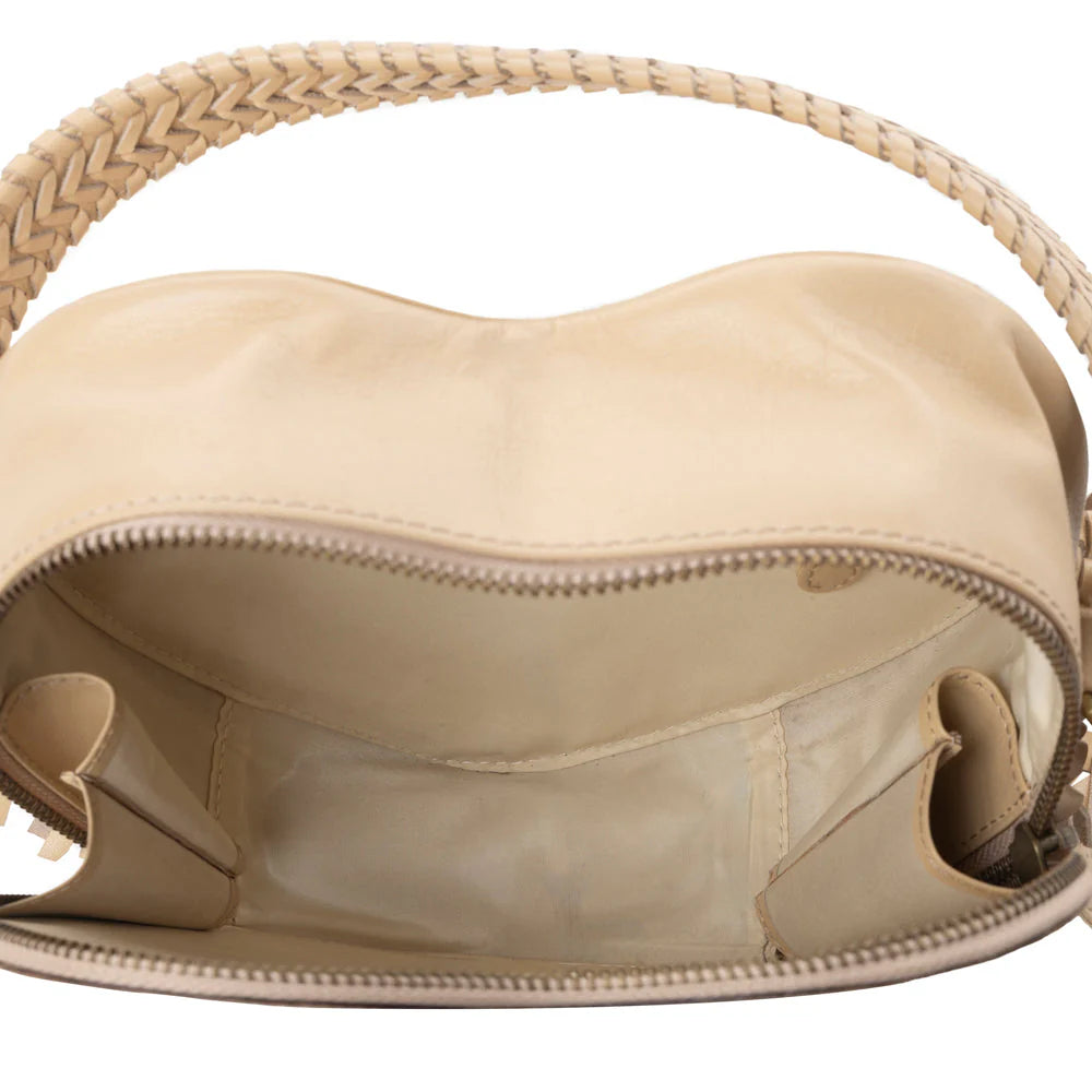 Beige handbag with a woven handle on a white background