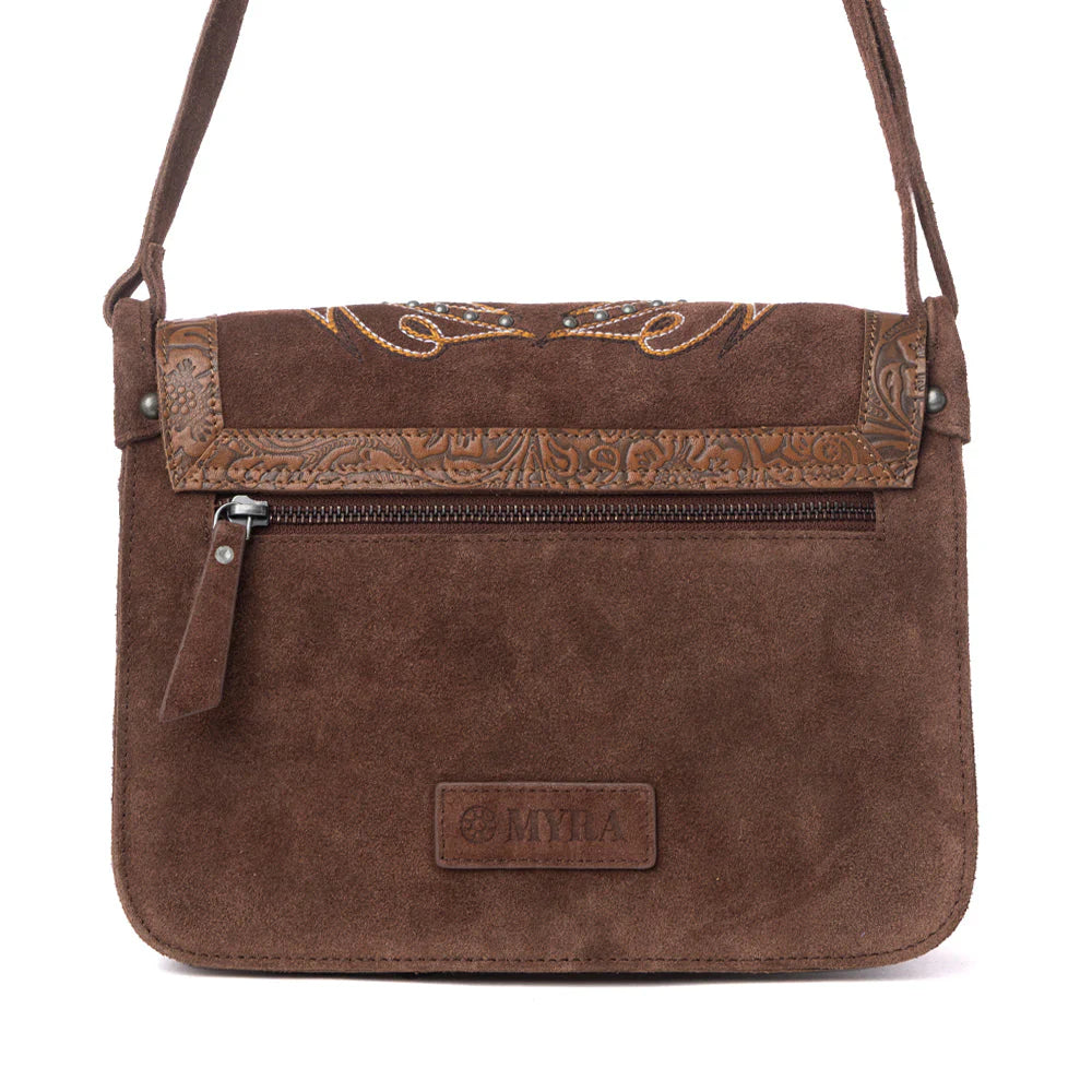 Brown leather handbag with intricate embossing and decorative elements on a white background