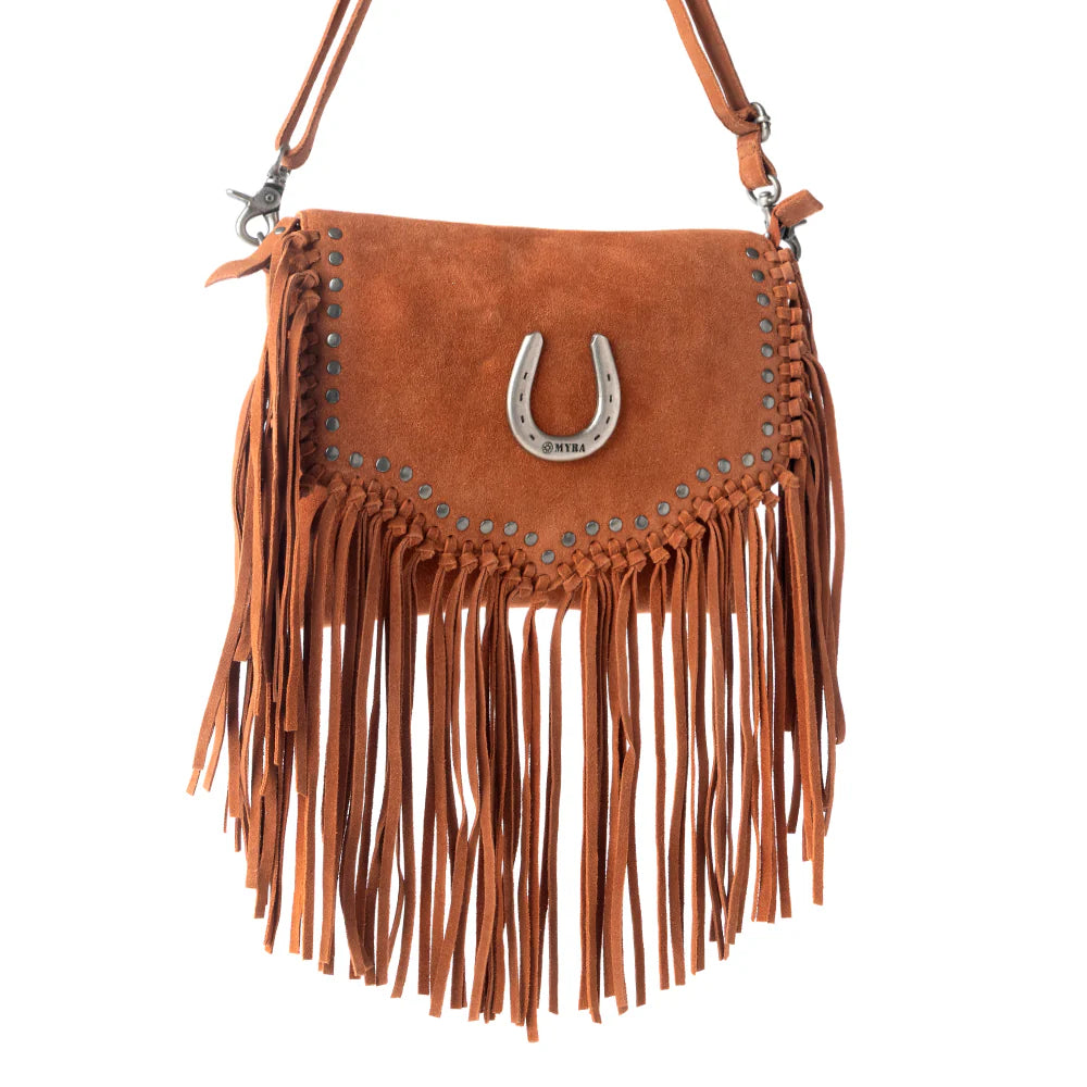 Brown suede handbag with fringe and a horseshoe charm on a white background