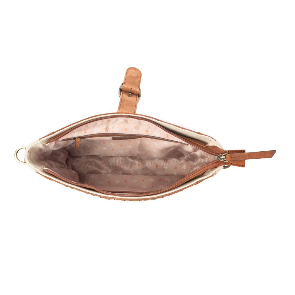 Yellowstone Lone Star Ivory Satchel Bag. Open handbag with brown leather interior and strap on a white background