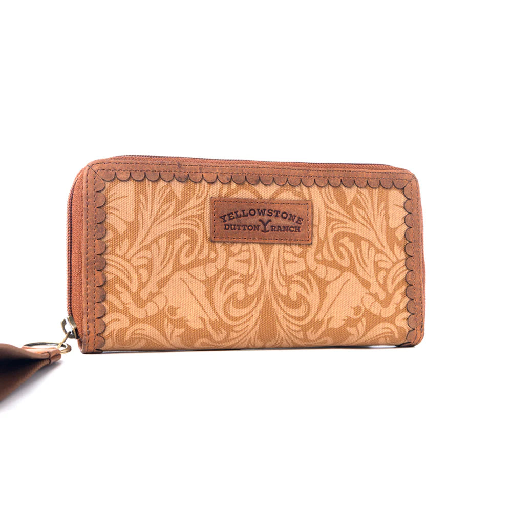 Yellowstone Montana Amber Wallet. Brown leather wallet with intricate patterns and &#39;Yellowstone&#39; branding on a white background