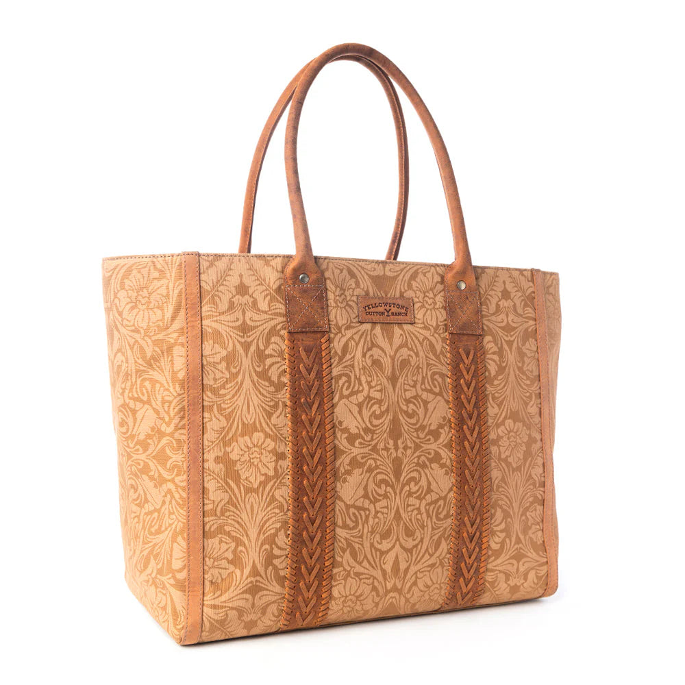 Yellowstone Bunkhouse Amber Weekender Bag. Brown leather tote bag with intricate patterns on a white background