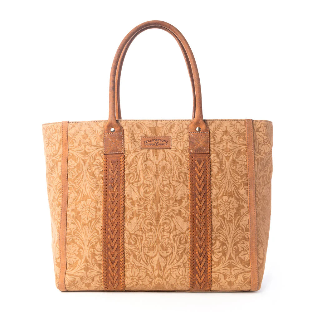 Yellowstone Bunkhouse Amber Weekender Bag. Brown leather tote bag with intricate patterns on a white background