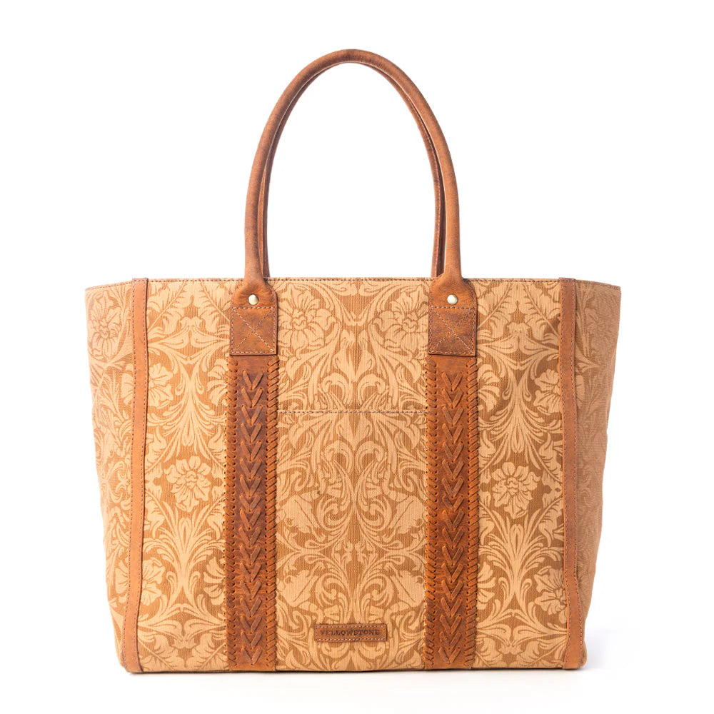 Yellowstone Bunkhouse Amber Weekender Bag. Brown leather tote bag with intricate patterns on a white background