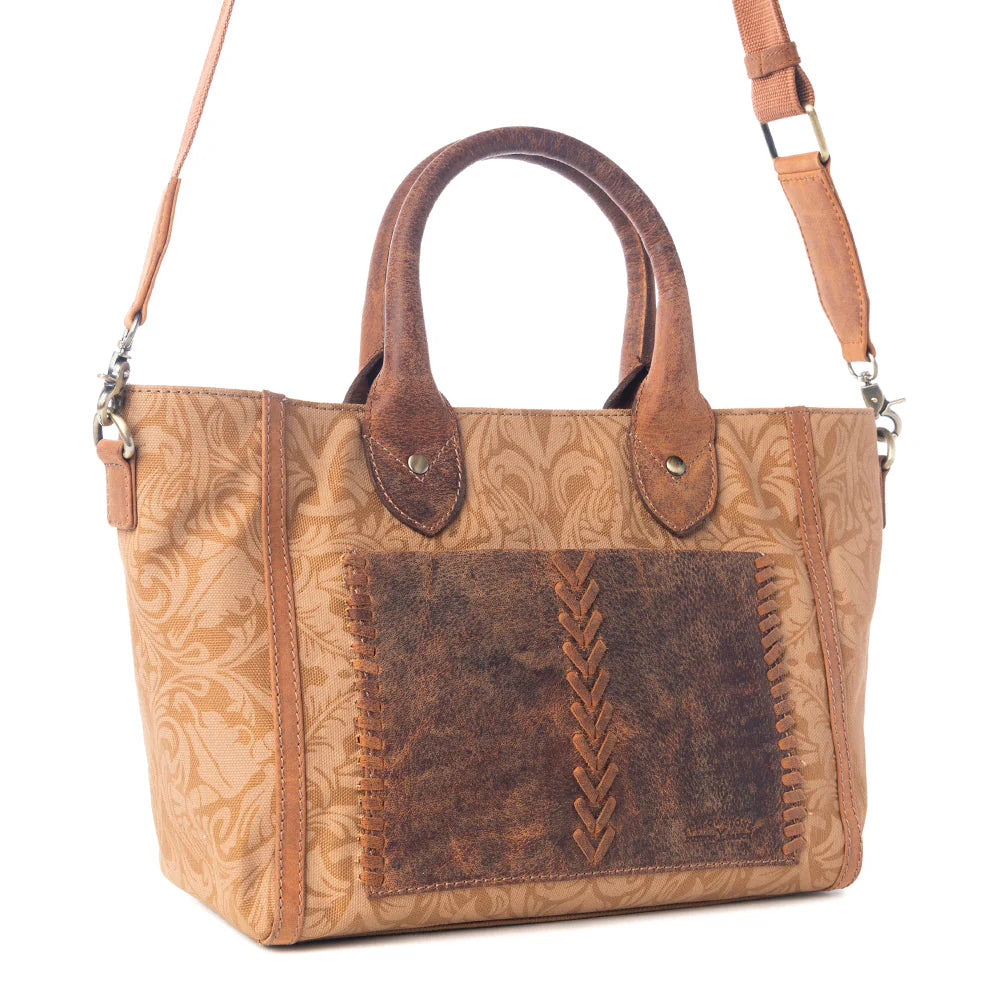 Yellowstone Valley Mini CrossBody Bag in Amber. Brown leather handbag with intricate patterns on a white background