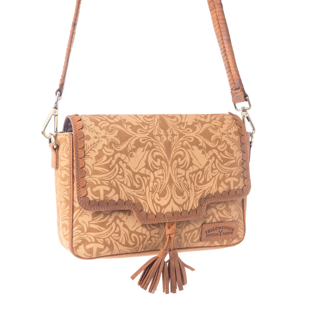 Yellowstone Sierra Amber Tassle Crossbody Bag. Brown leather handbag with intricate patterns and a tassel on a white background