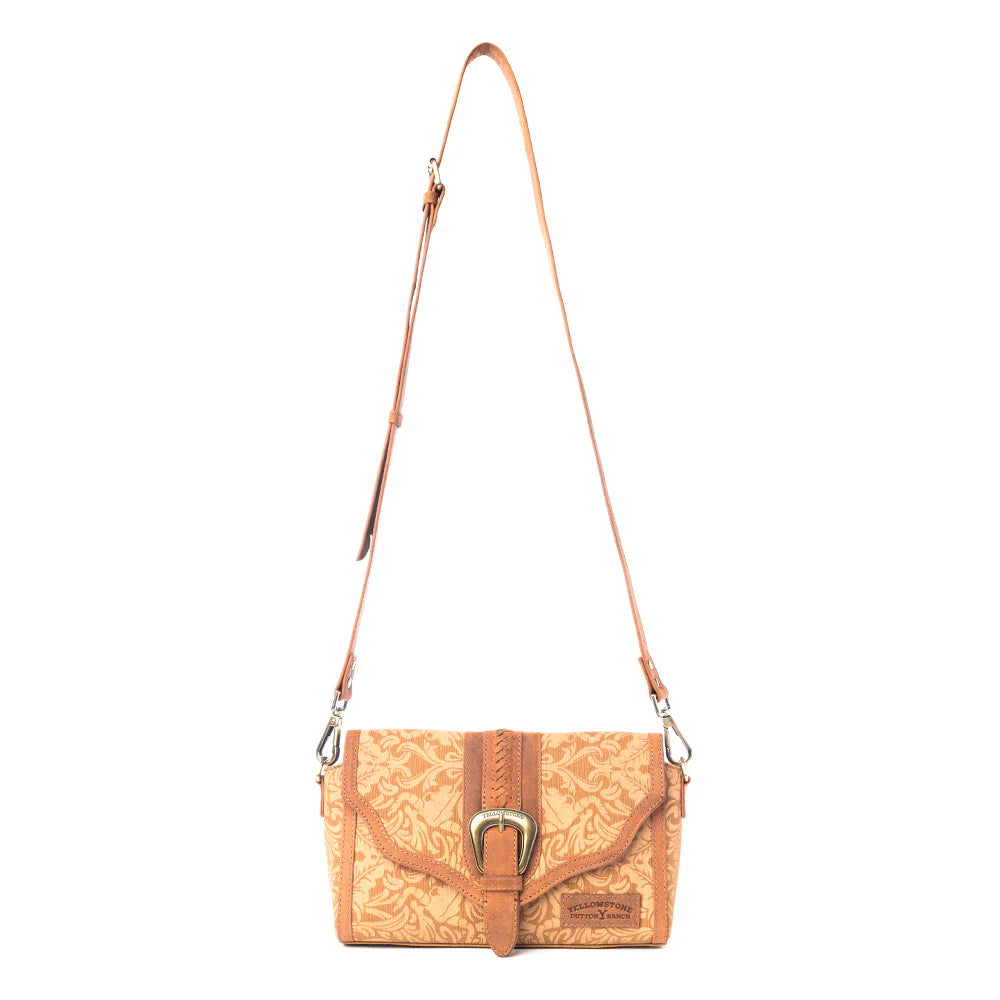 Yellowstone Maverick Sky Crossbody with Buckle in Amber. Brown leather handbag with a strap on a white background