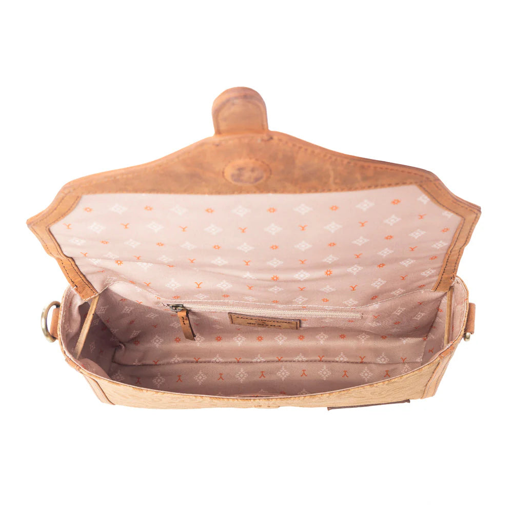 Yellowstone Maverick Sky Crossbody with Buckle in Amber. Open tan handbag with polka dot interior on a white background