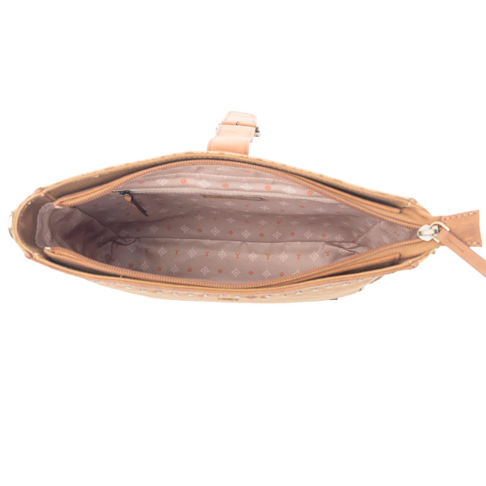 Yellowstone Montana Amber Buckle Sling Bag. Open beige handbag with polka dot interior on a white background