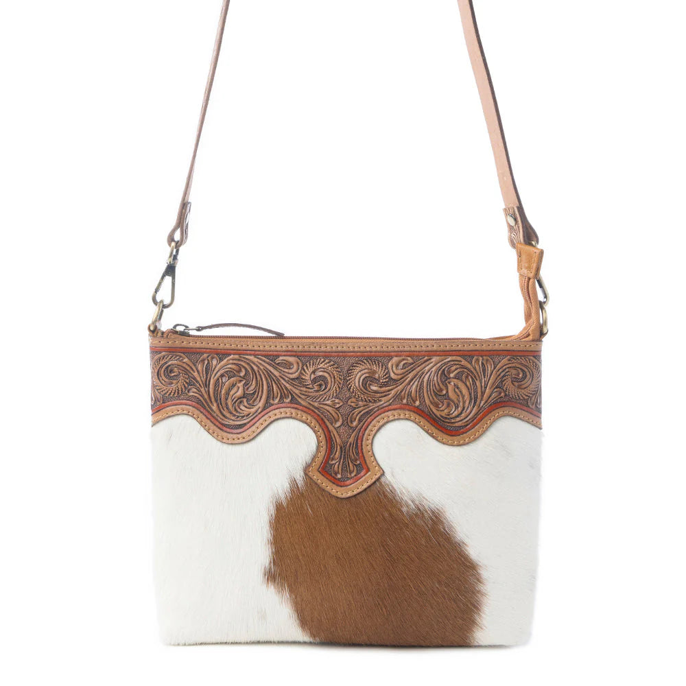 Sienna Grace Handtooled Hairon Leather Bag in Western Copper. Brown and white cowhide handbag with intricate leatherwork on a white background