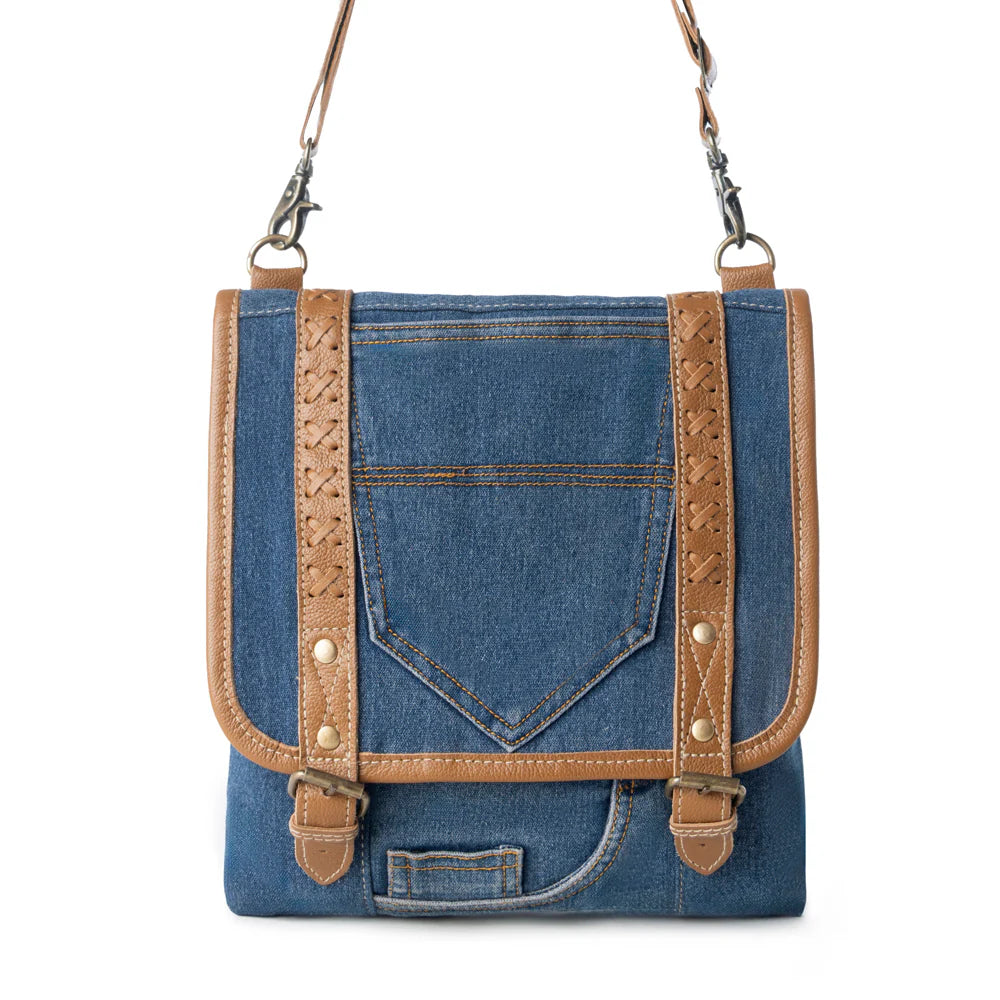 Denim bag with brown leather accents on a white background