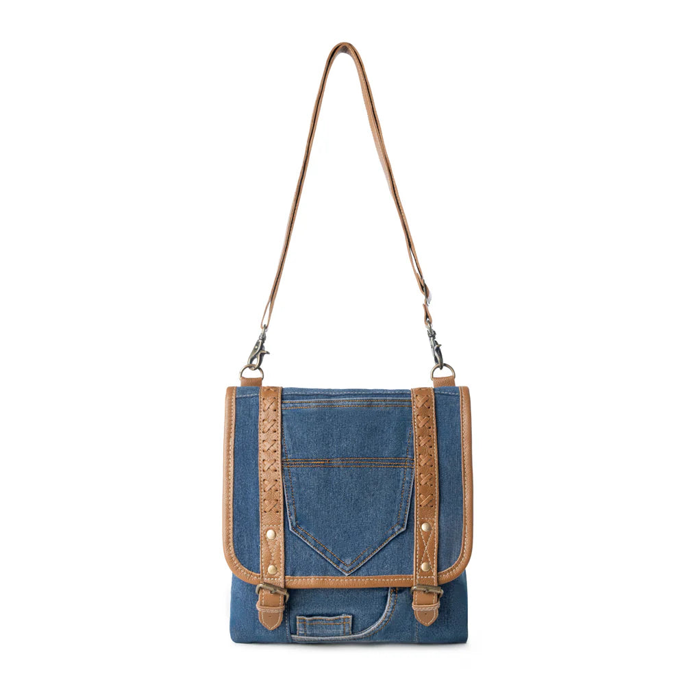 Blue denim crossbody bag with brown leather accents on a white background