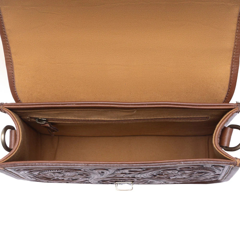 Brown leather handbag with intricate designs on a white background