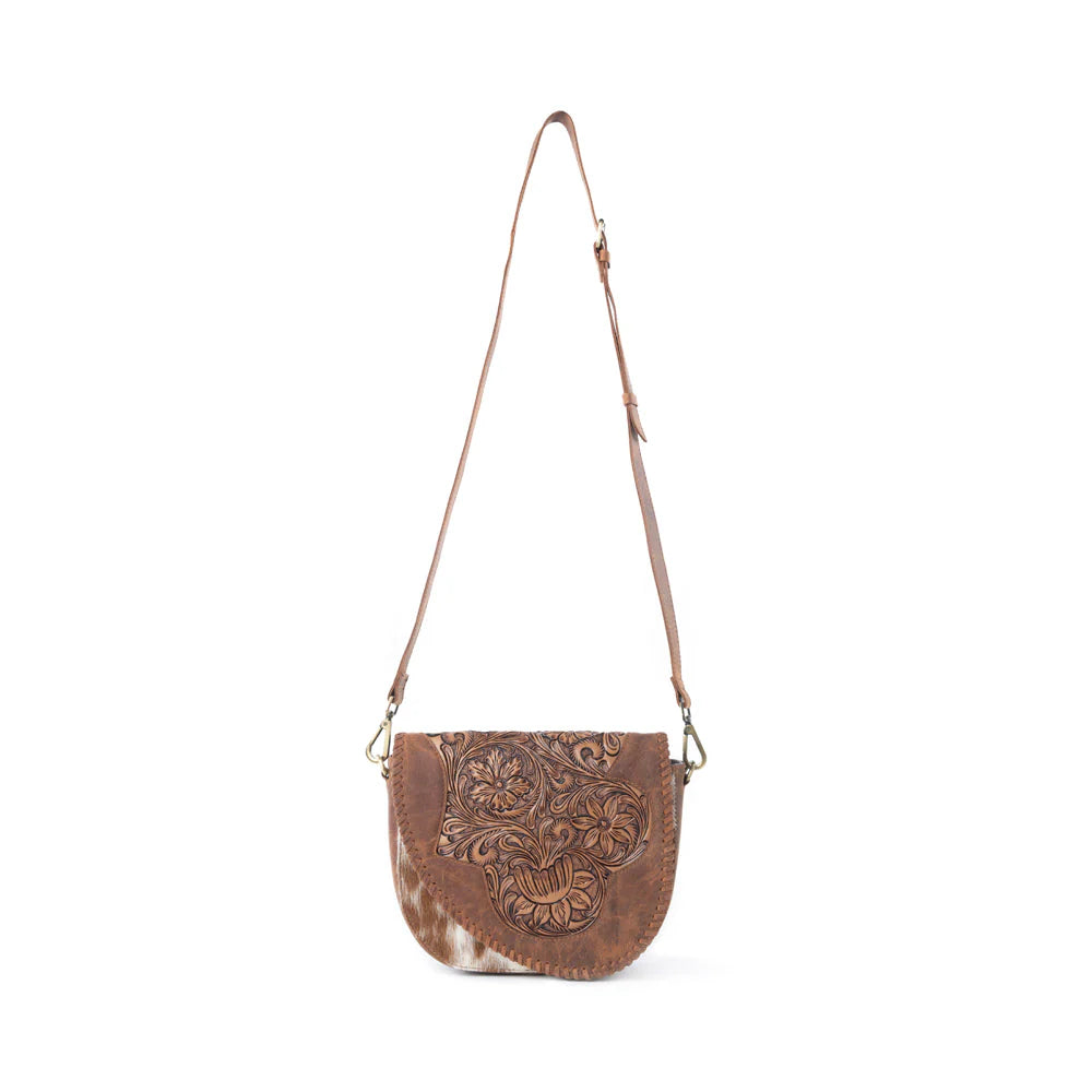 Brown leather crossbody bag with floral embossing on a white background