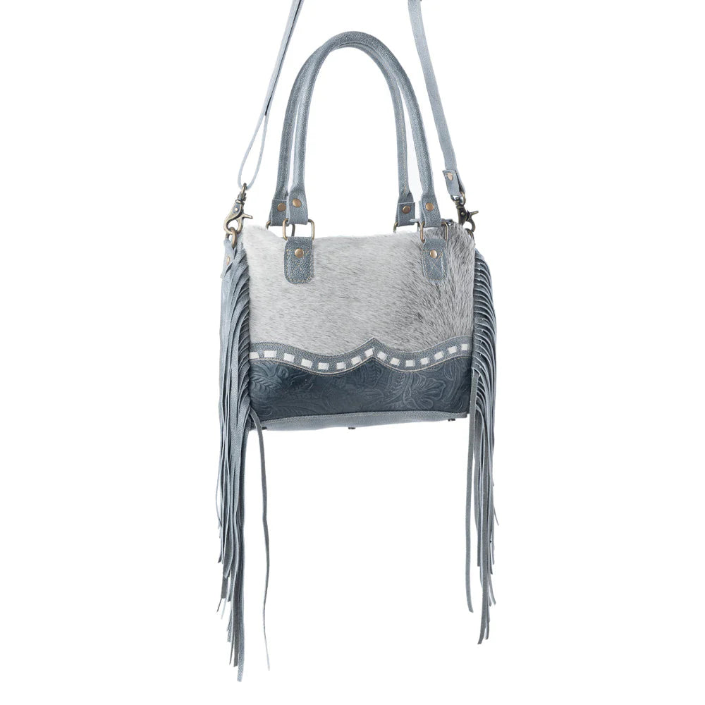 Gray handbag with fringe details on a white background