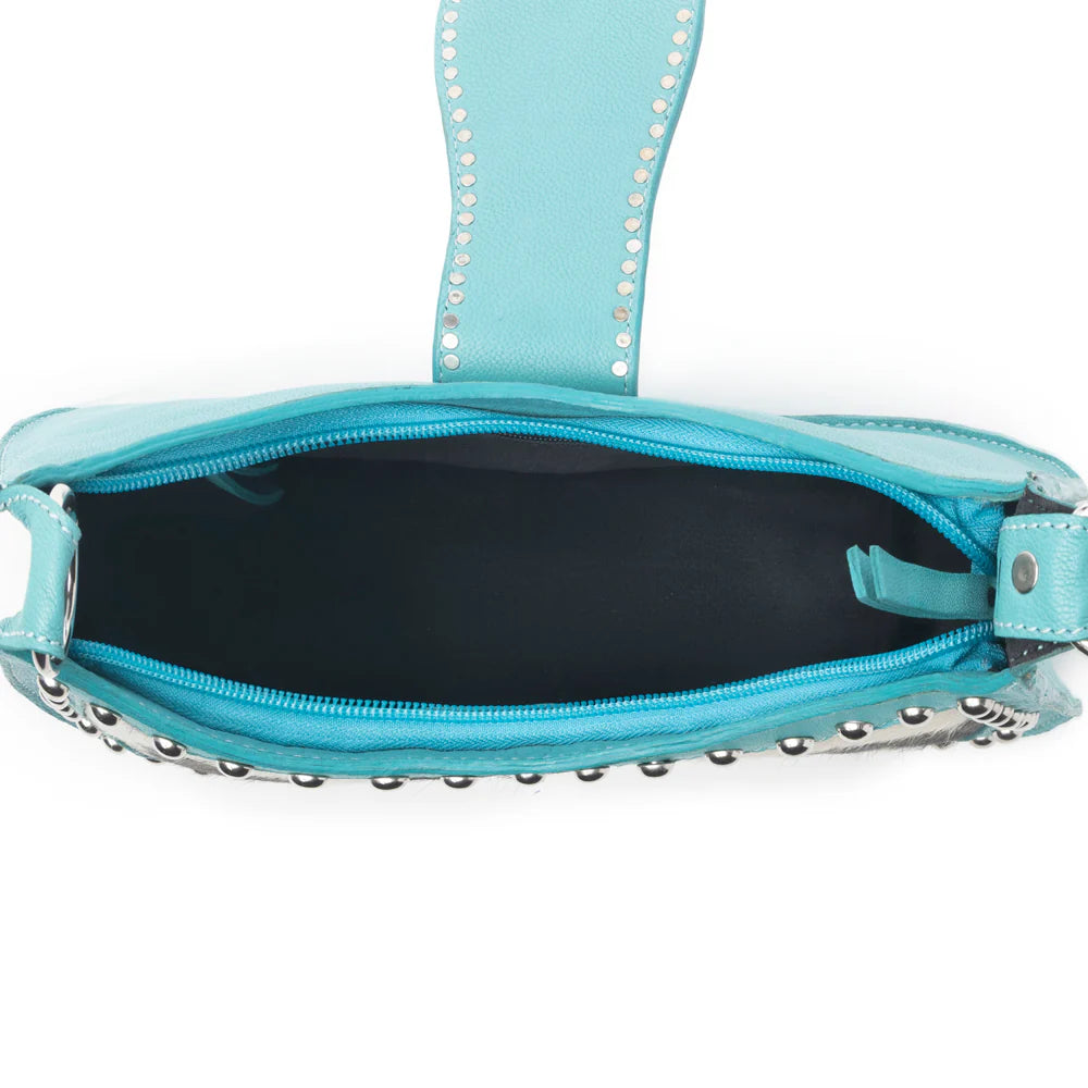 Turquoise handbag with studded details on a white background