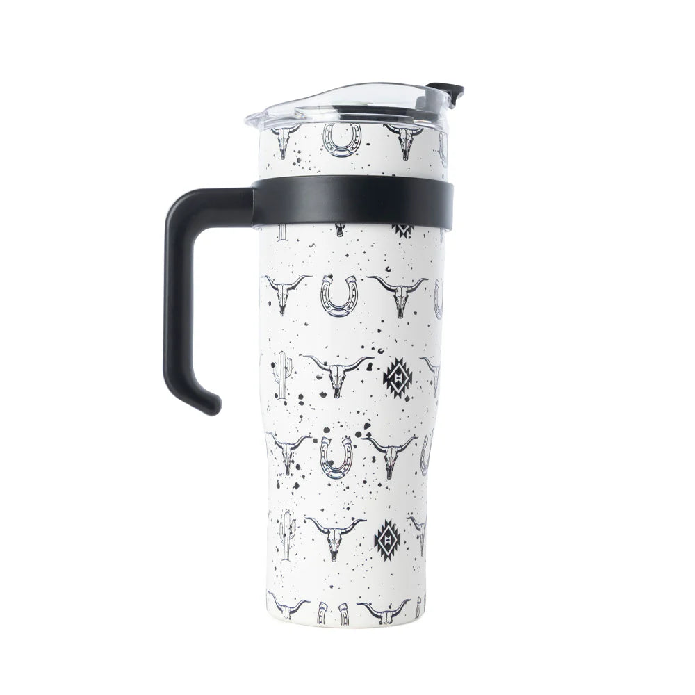 Clear pitcher with black handle and white pattern on a white background