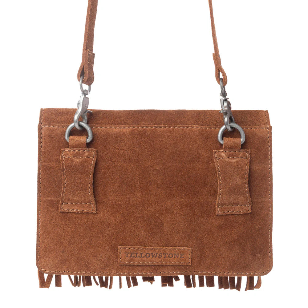Brown leather crossbody bag with fringes and 'Yellowstone' branding on a white background