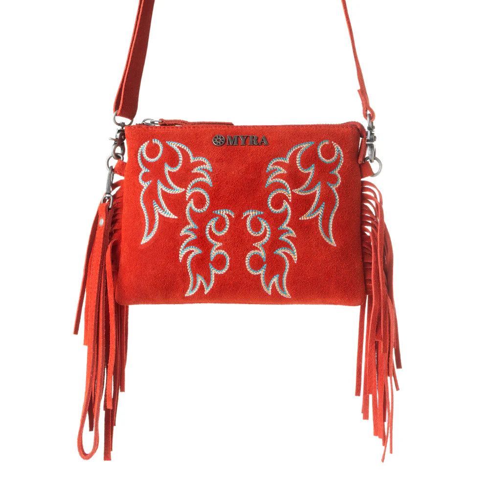 Red handbag with white embroidery and fringes on a white background
