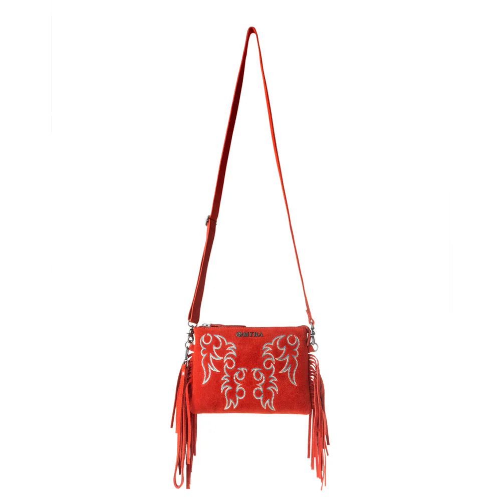 Red handbag with white patterns and fringes on a white background