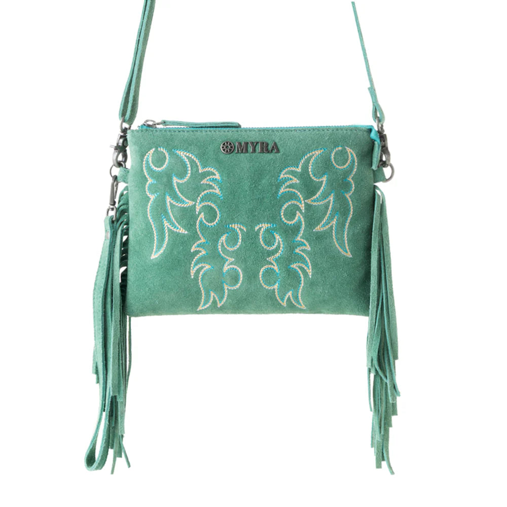 Green handbag with embroidery and fringes on a white background