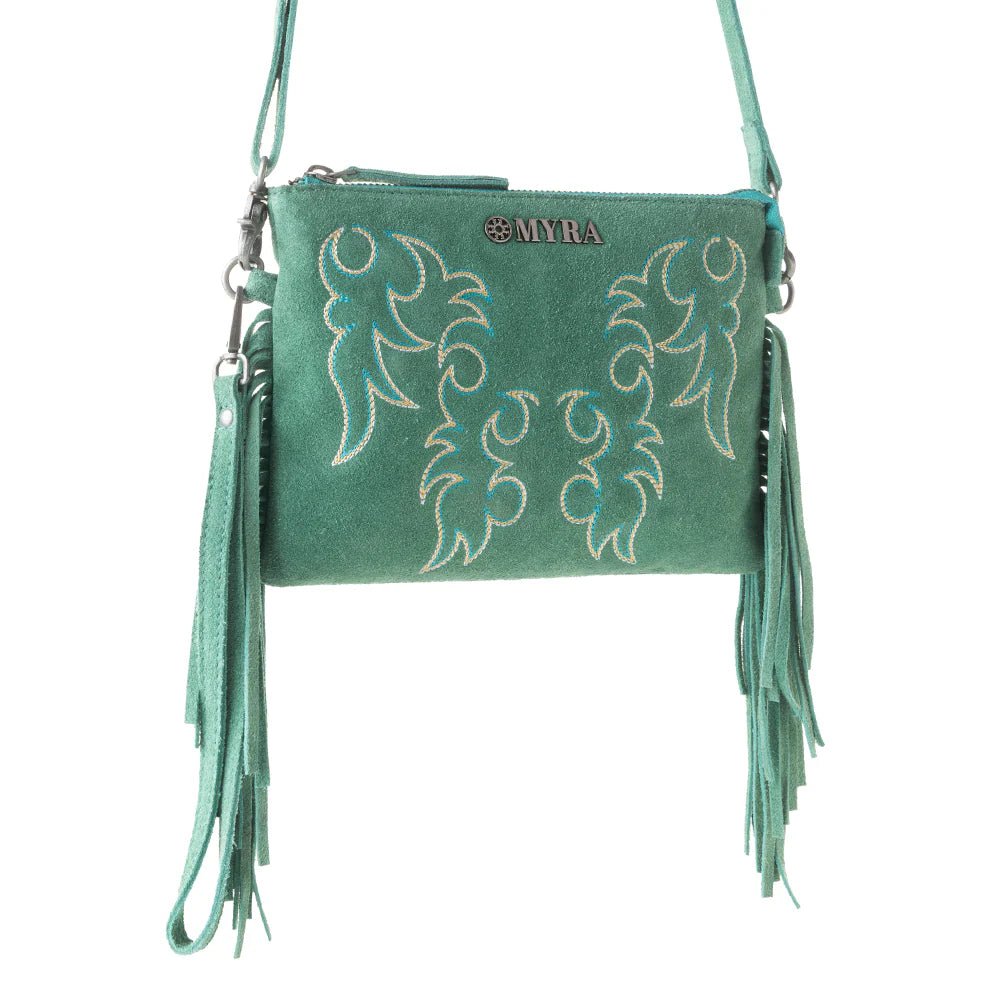 Green handbag with embroidery and fringes on a white background