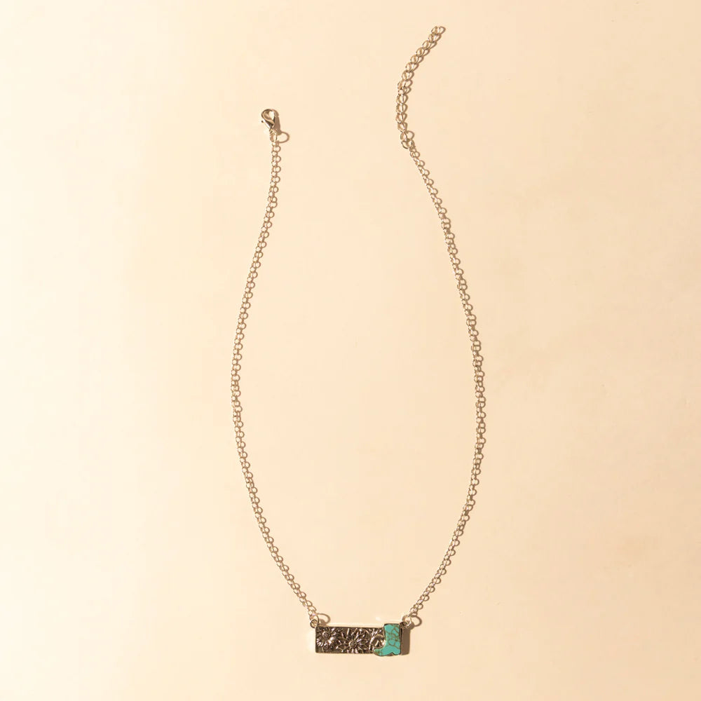 Necklace with a small rectangular pendant on a beige background