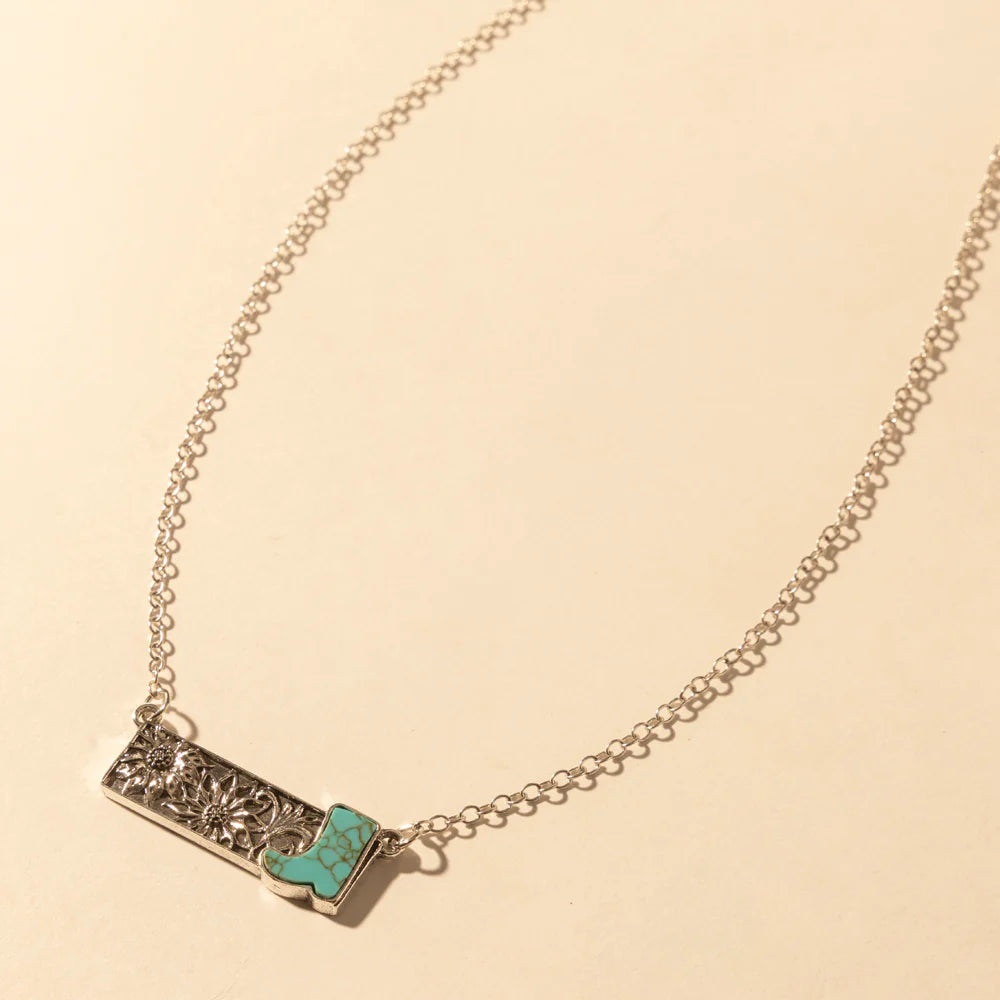 Necklace with a turquoise pendant on a beige background
