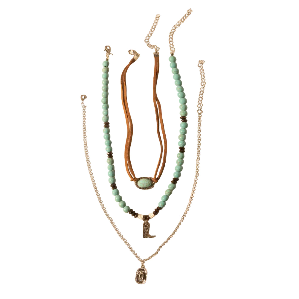 Set of layered necklaces with turquoise beads and charms on a beige background