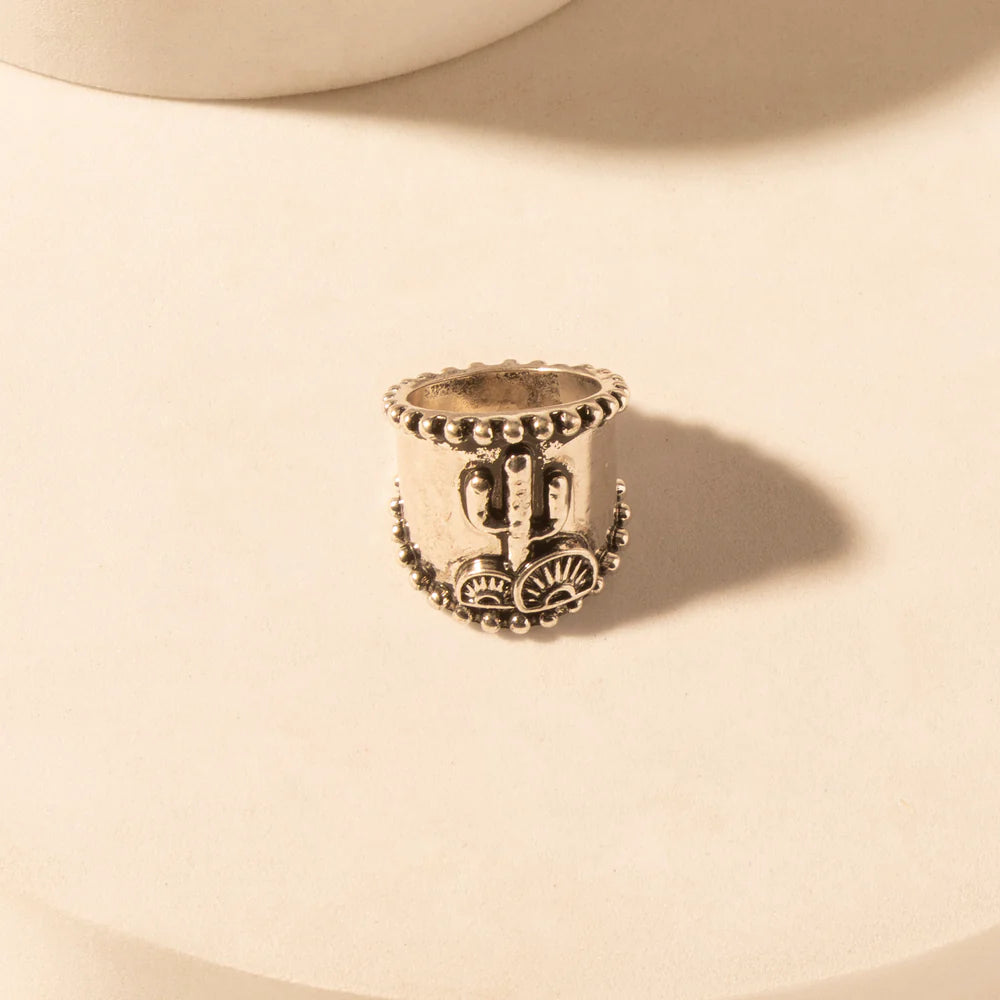 Decorative metal bead on a beige surface