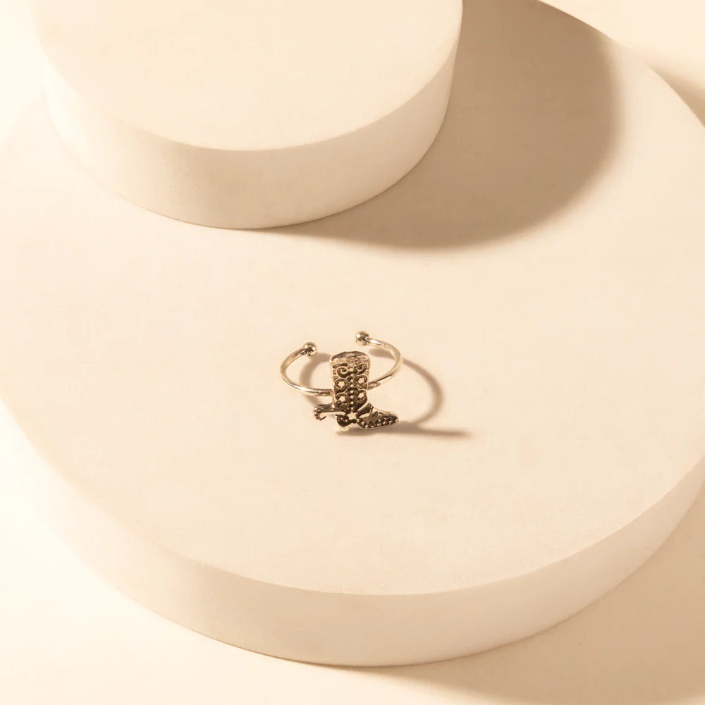 Silver ring with a unique design on a beige surface