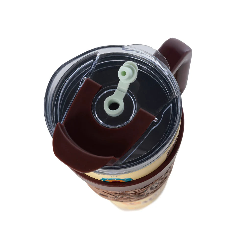 Brown tumbler with a clear lid on a white background