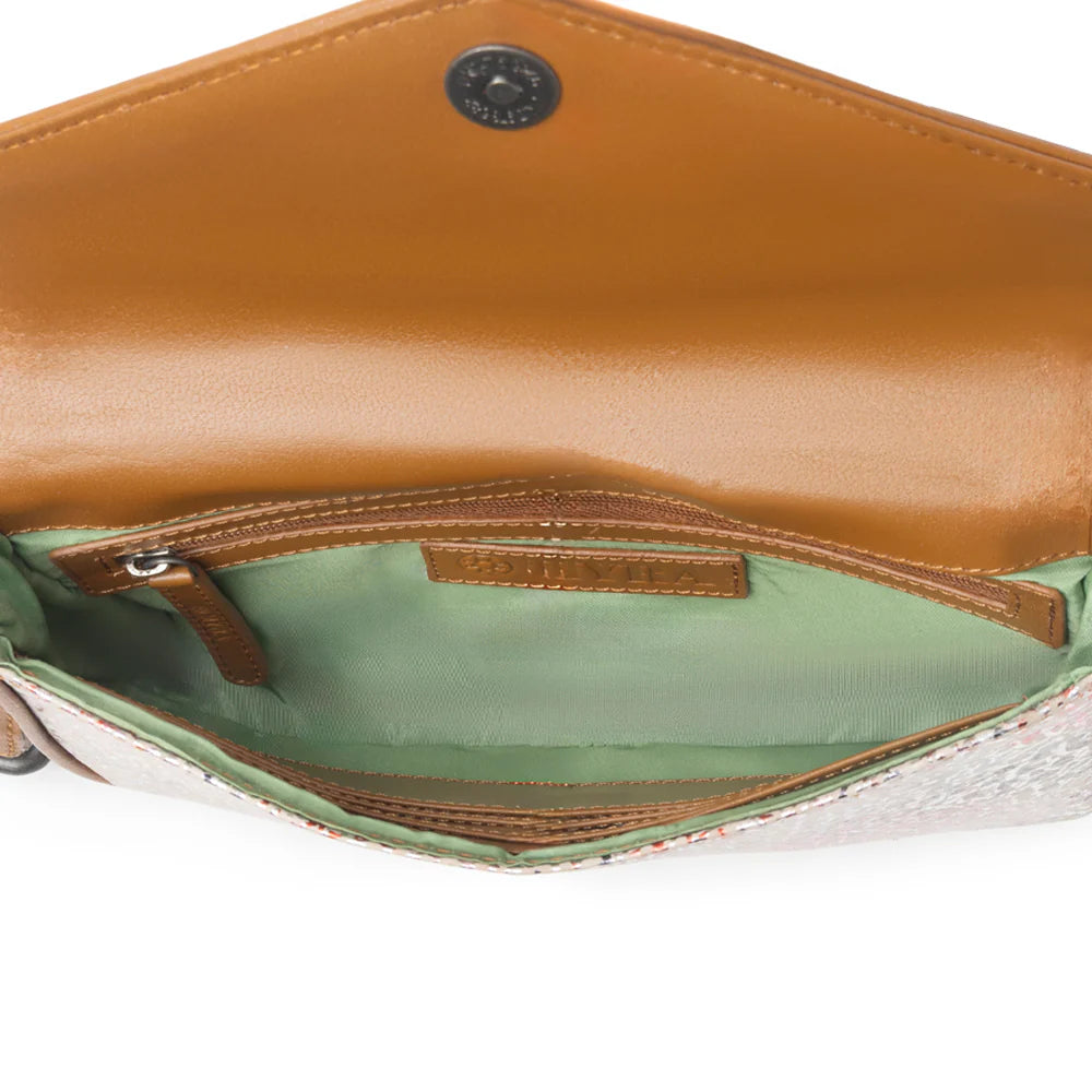 Close-up of a brown leather handbag with a white interior