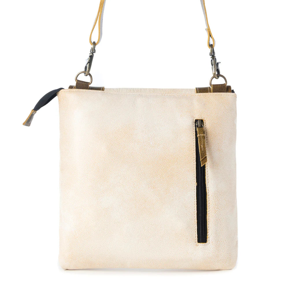 Beige crossbody bag with black accents on a white background