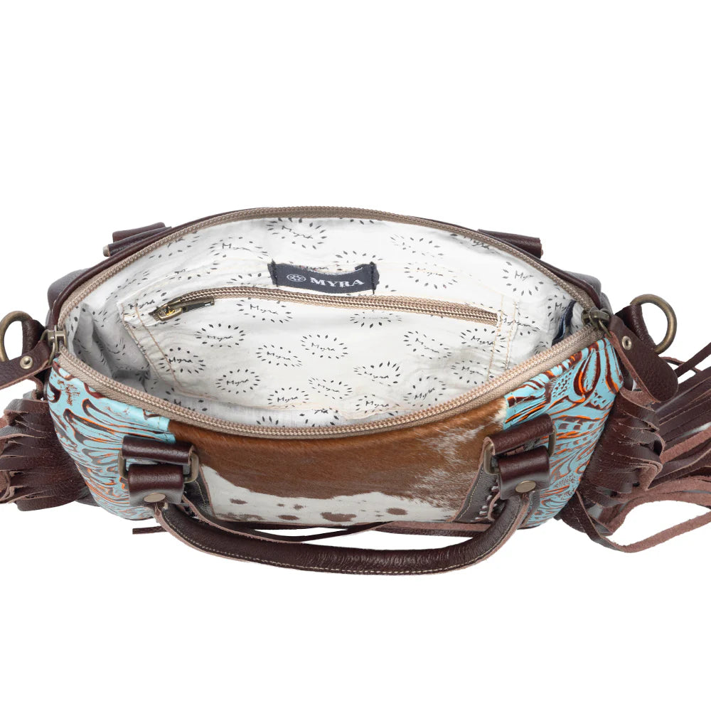 Brown leather crossbody bag with floral pattern on a white background