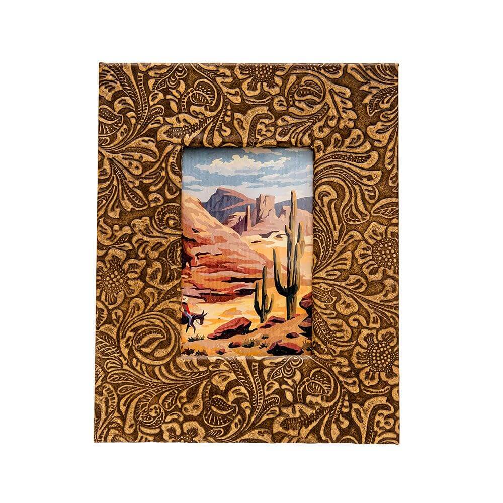 Neo Photo Frame. A photo frame with a paisley pattern, predominantly in brown tones, with a picture of a desert landscape visible through the framed area.