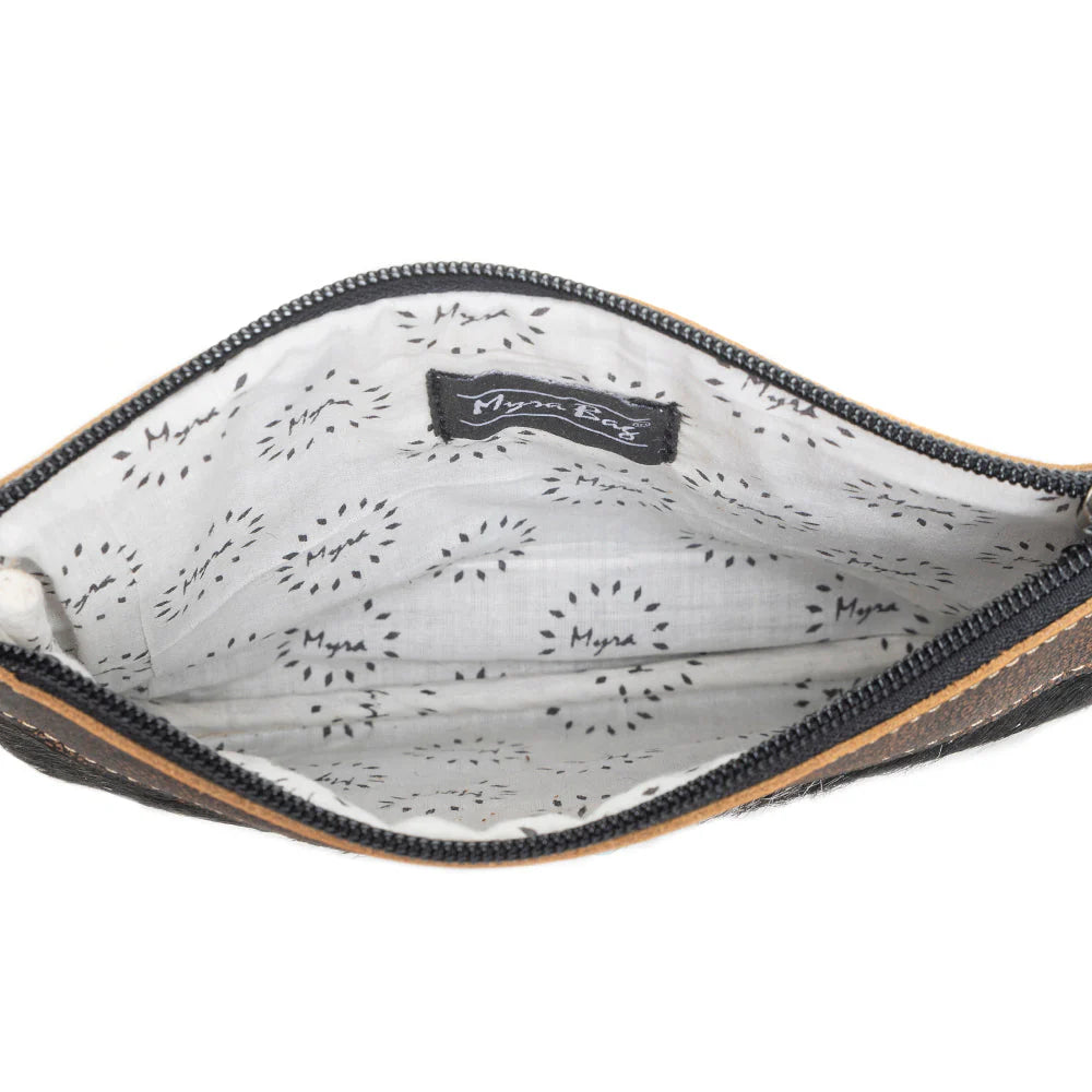 Eye of the Goddess Crossbody Bag in Black. Close-up of a pouch with a patterned interior and visible brand logo.