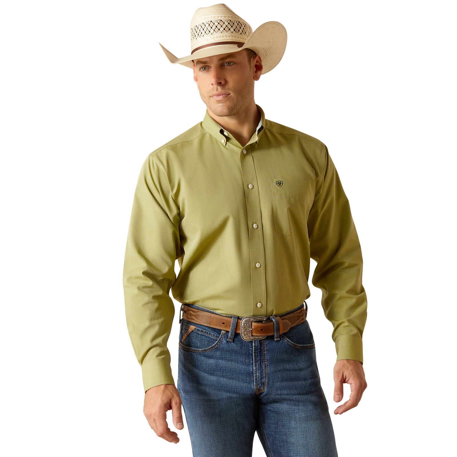 Ariat Men's Wrinkle Free Solid Pinpoint L/S Western Shirt. A man wearing a green long-sleeved Ariat Western shirt with a contrast collar, button-up shirt with wrinkle-free finish, standing next to a pair of blue jeans.