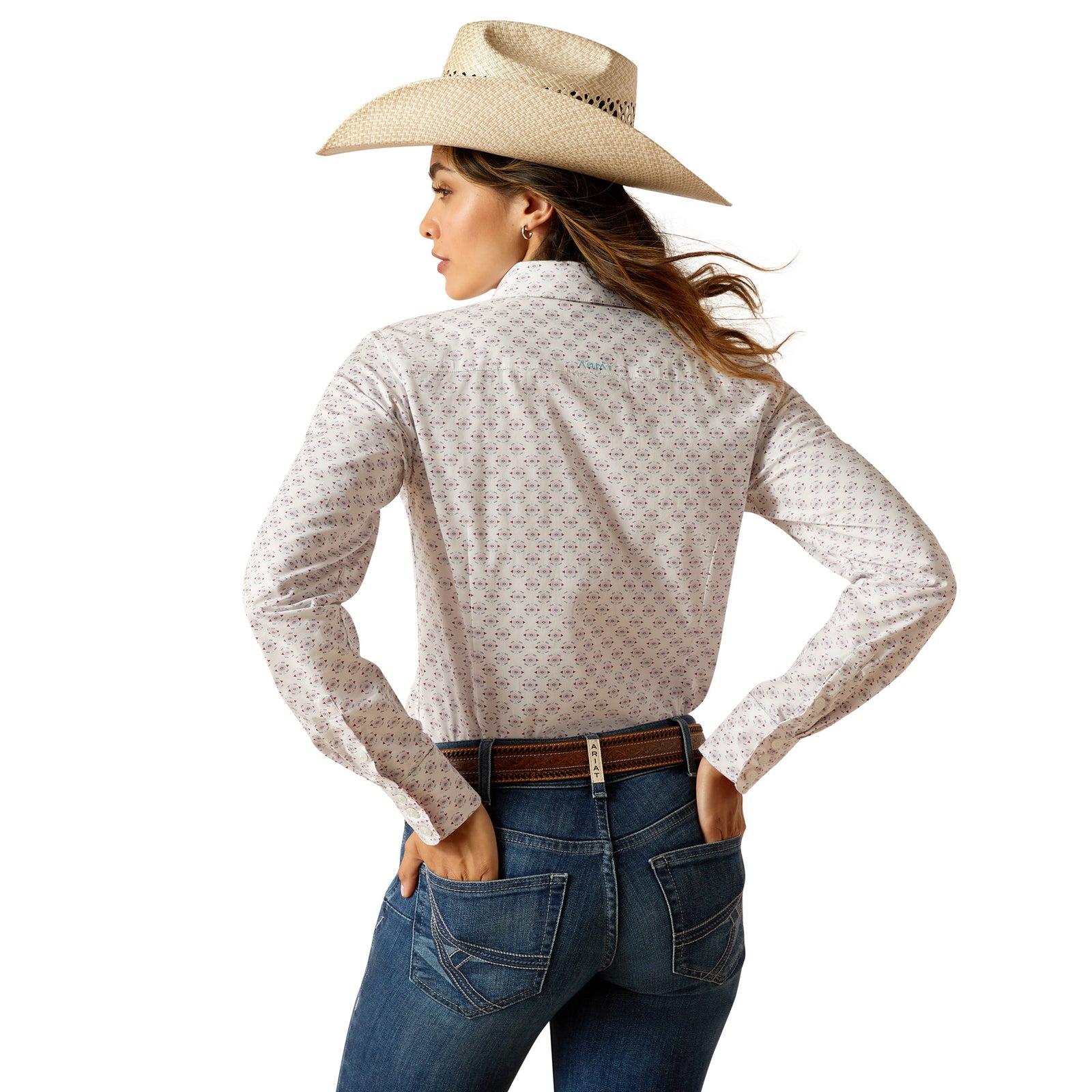 Ariat Women's Kirby L/S Western Shirt. A woman wearing a long-sleeved, geometric patterned Western shirt with a single chest pocket, paired with a cowboy hat.