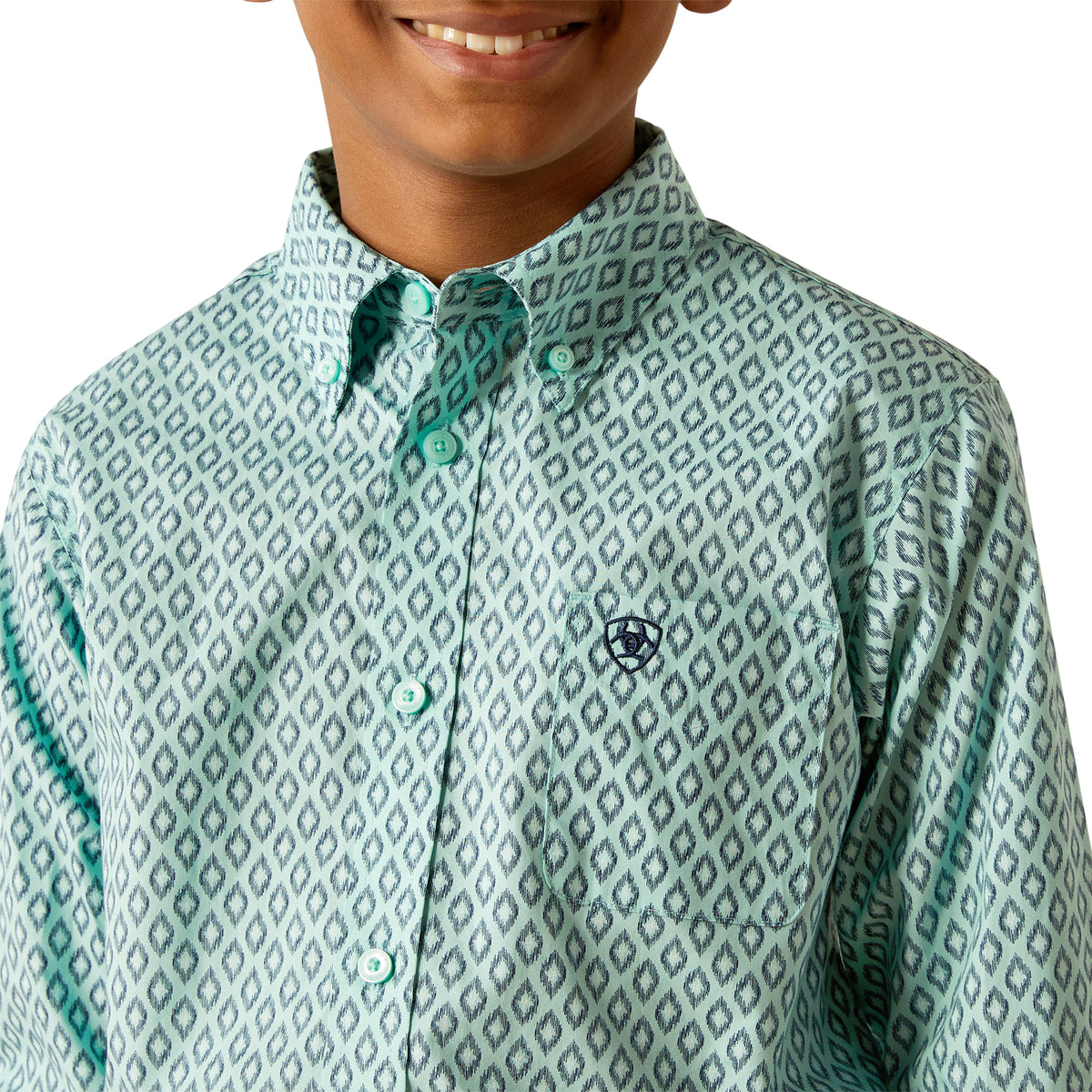 Ariat Boy's Canyon L/S Western Shirt. Child wearing a patterned shirt with a visible brand logo on a white background