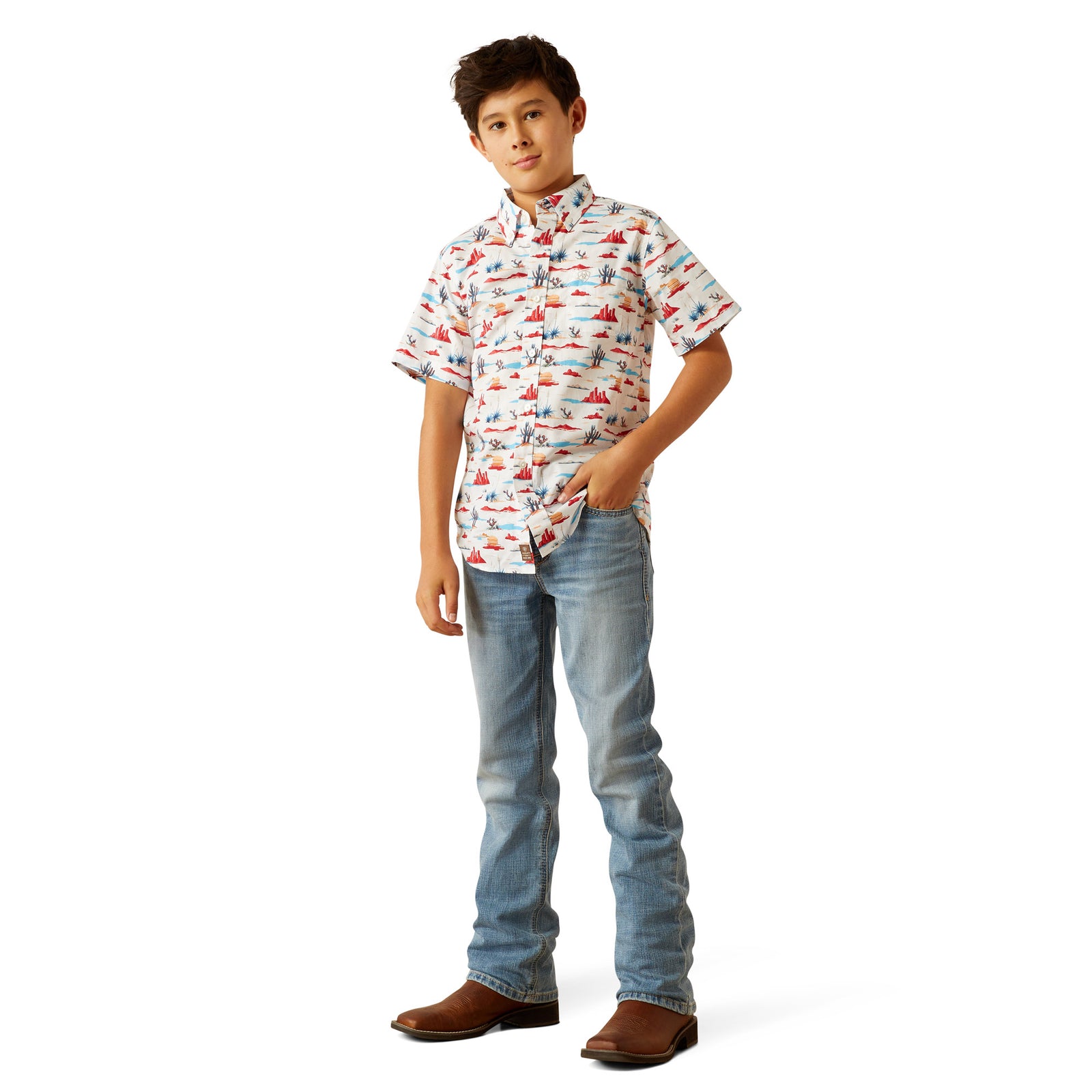 Ariat Boy's Scout S/S Western Shirt. Young boy wearing a patterned shirt and jeans on a white background
