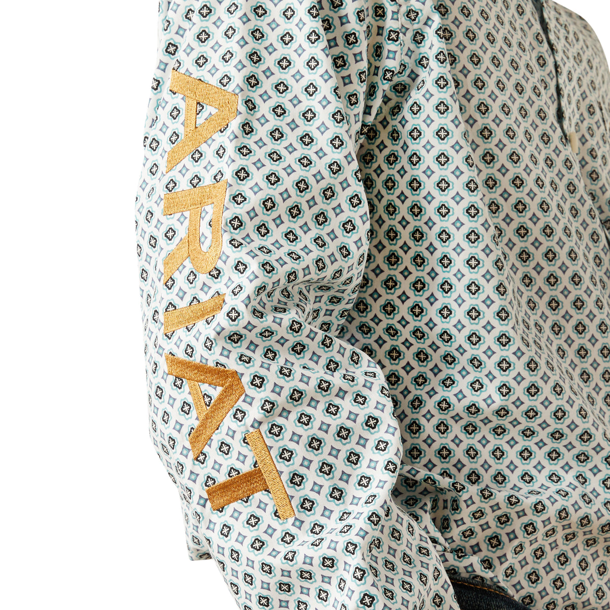 Ariat Boy's Team Franklin L/S Western Shirt. Patterned fabric with 'ARIA' text in gold on a white background