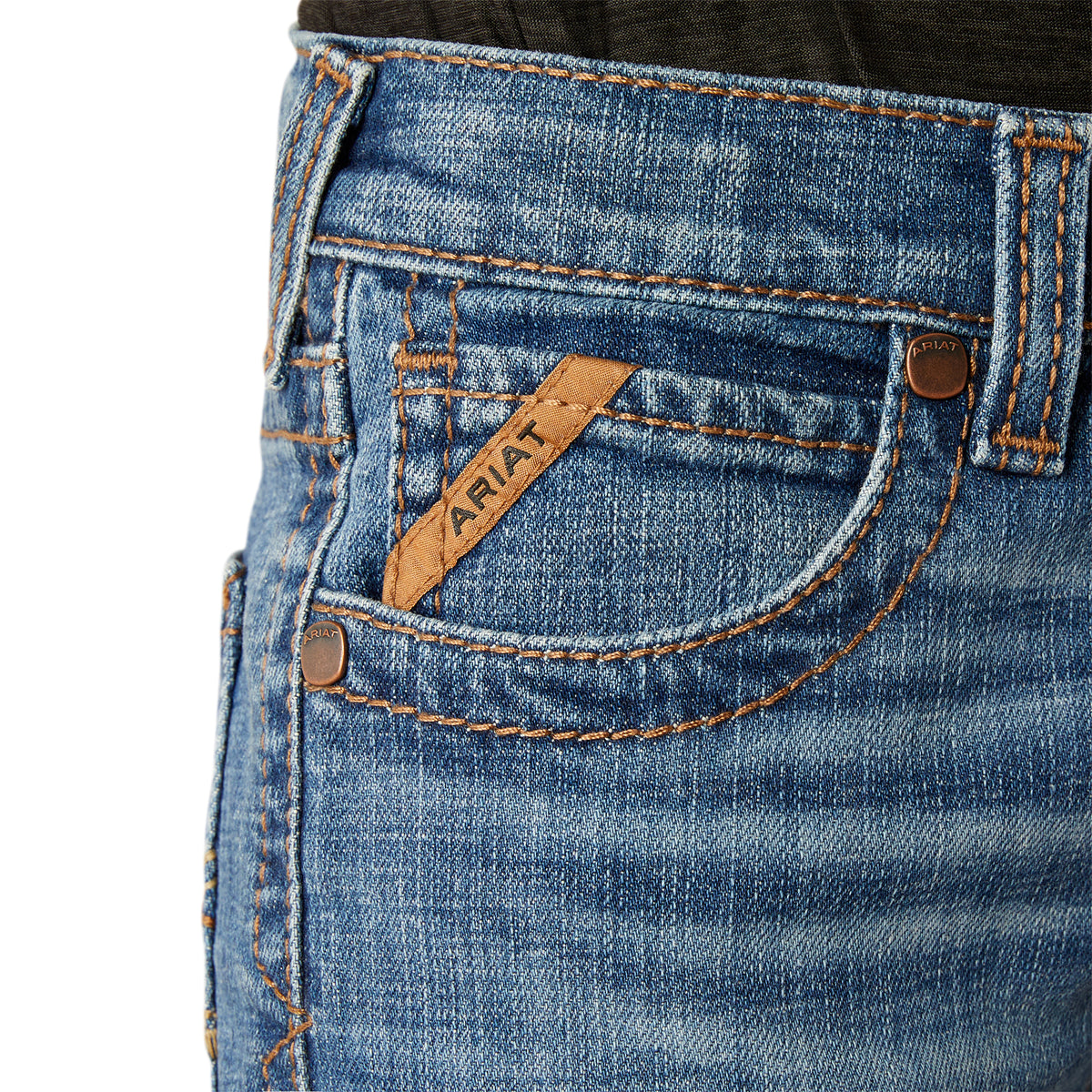 Ariat Boy's B5 Norwich Slim Fit Jean. Close-up of blue jeans with a brand label on a white background