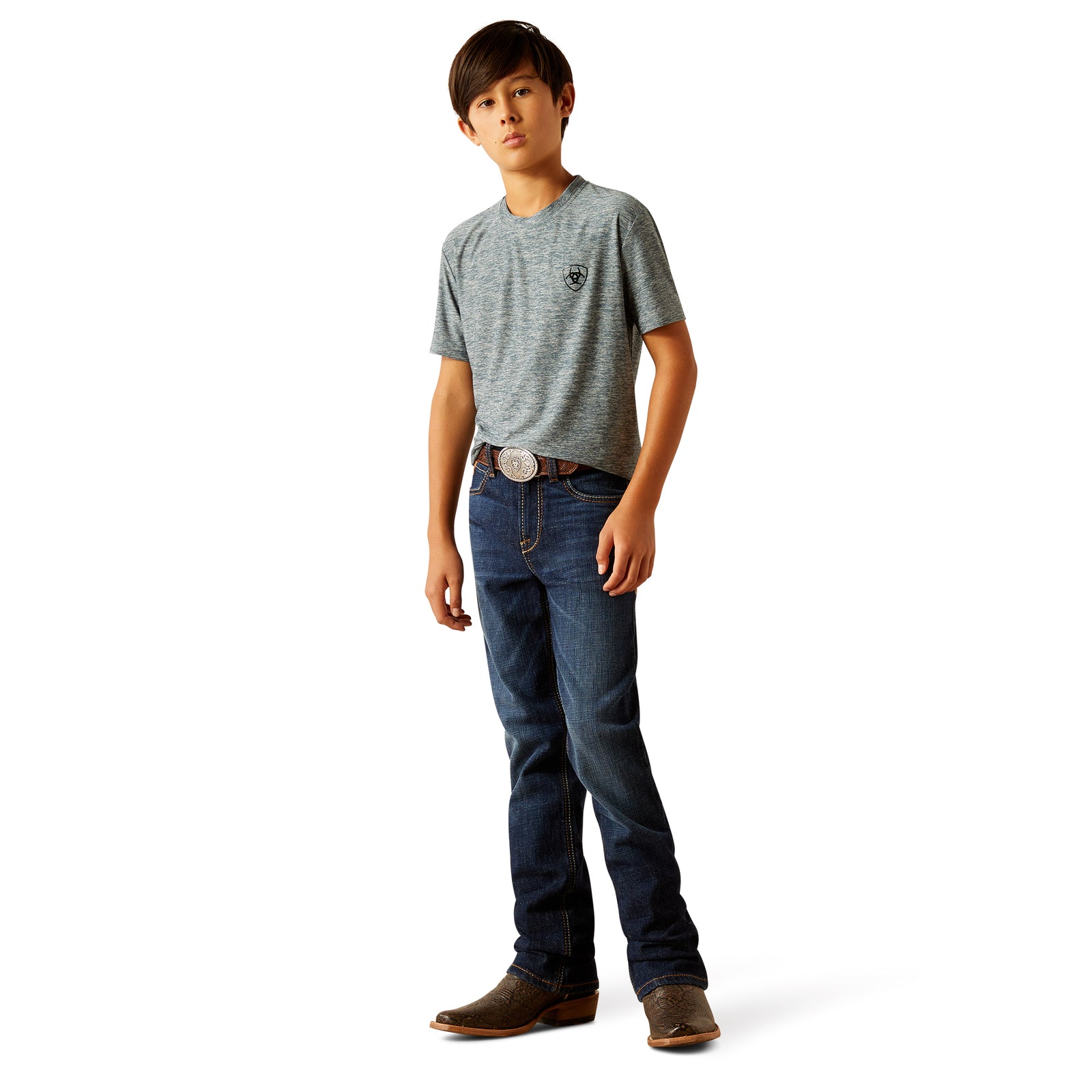 Ariat Boy's B4 Rolland Relaxed Fit Jean. A boy wearing a pair of Ariat brand blue jeans and brown boots.