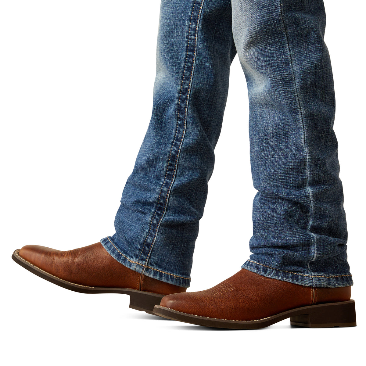Ariat Boy's B5 Slim Bennet Straight Leg Jean. Brown leather boots and blue jeans on a white background