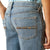 Ariat Boy's B4 Relaxed Jones Boot Cut Jeans. Close-up of blue jeans with a pocket detail on a white background