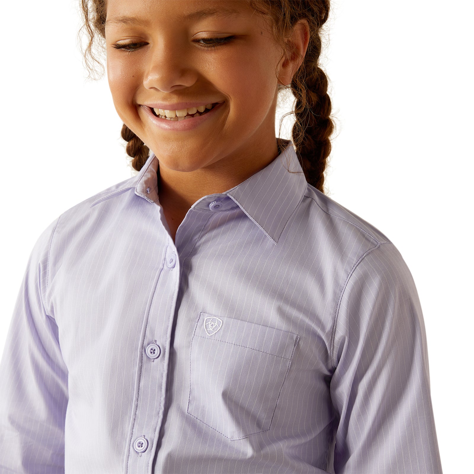 Ariat Girl's Kirby L/S Western Shirt. Young girl wearing a light purple button-up shirt with a small logo on a white background
