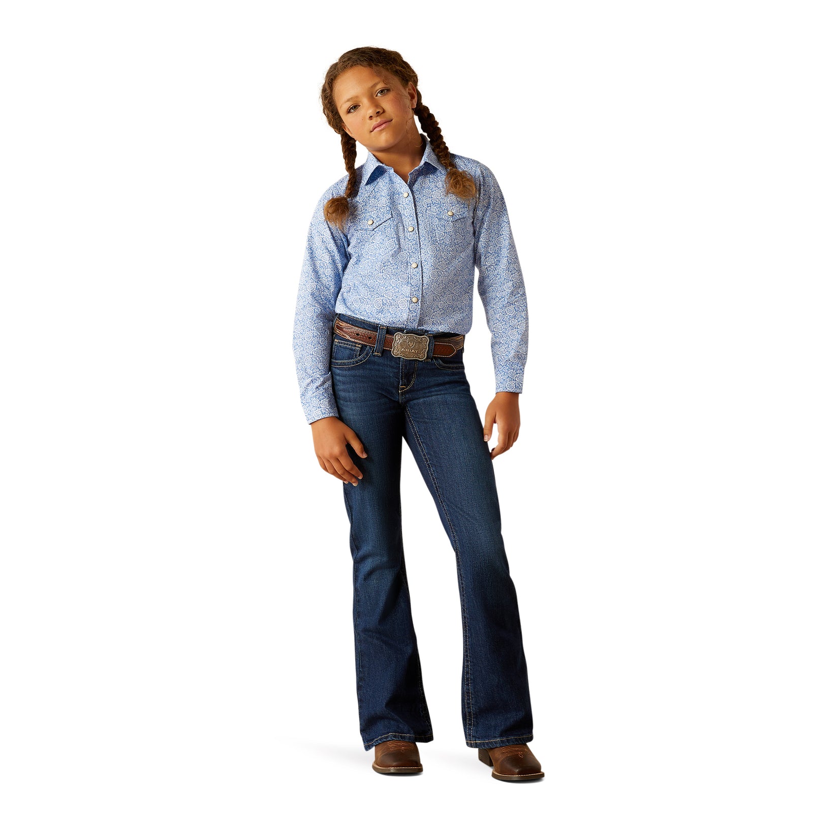 Ariat Girl's Shannon L/S Snap Western Shirt. Young girl wearing a blue denim shirt and jeans on a white background